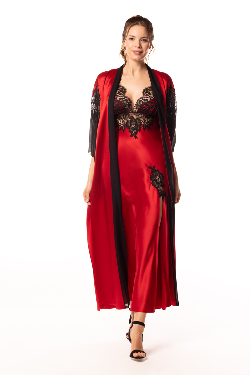 Woman wearing a red and black dress with lace details on a white background