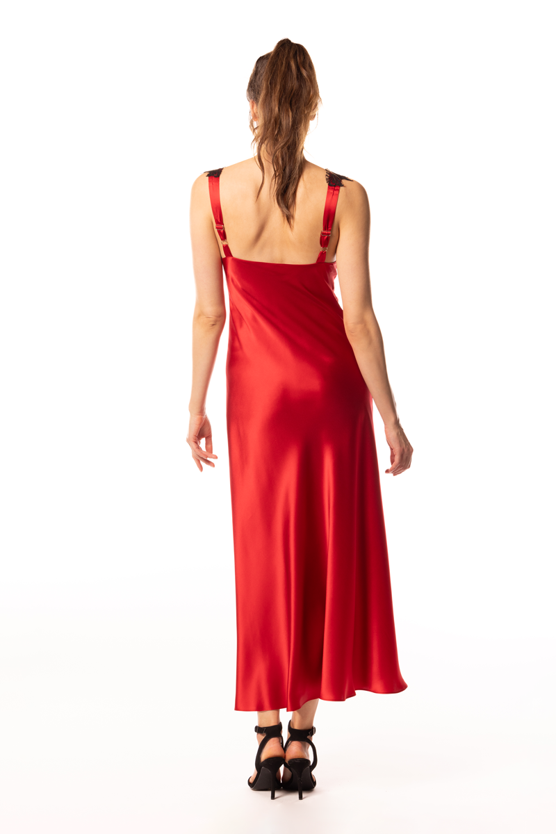 Woman wearing a red dress with thin straps on a white background
