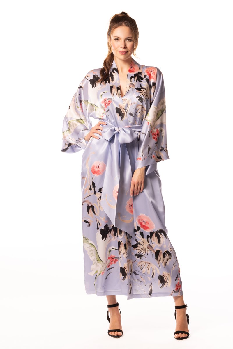 Woman wearing a floral silk robe on a white background