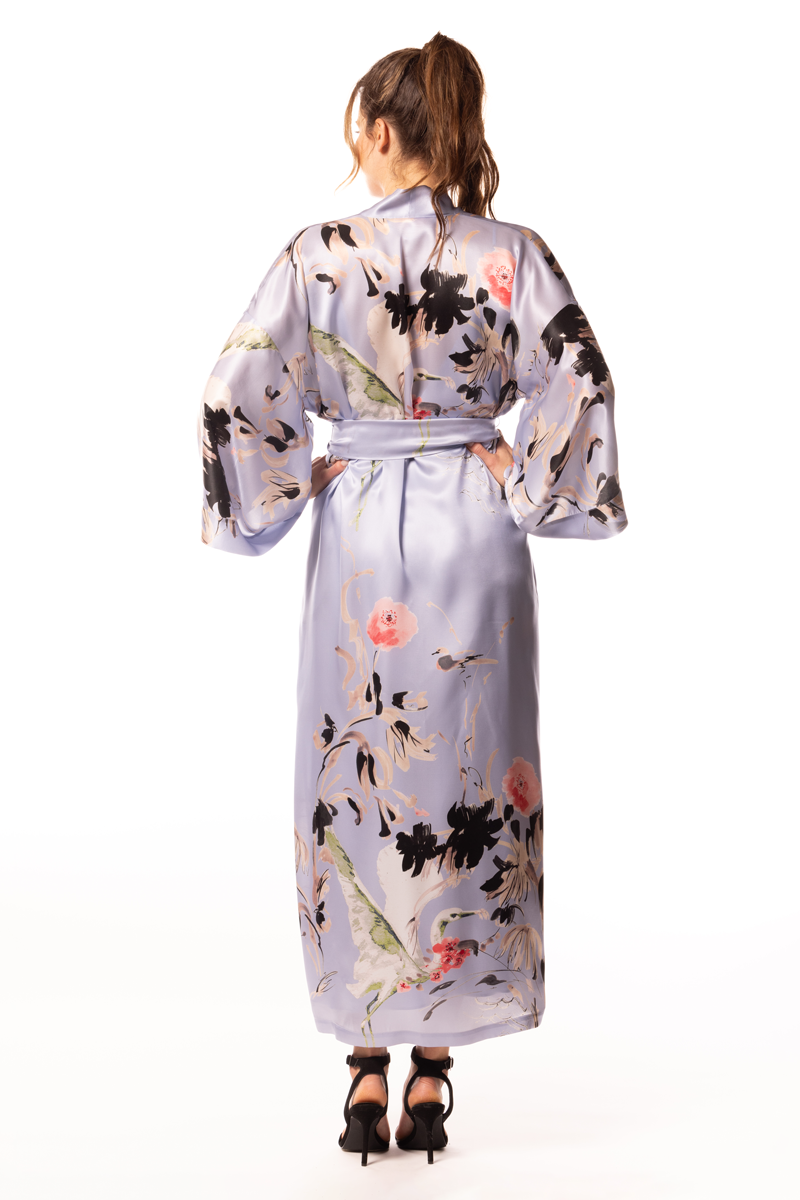 Woman wearing a floral silk robe on a white background