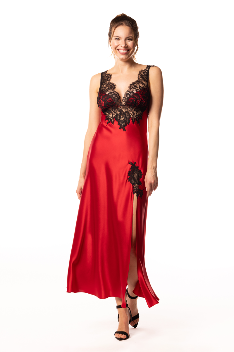Woman wearing a red satin nightgown with black lace details on a white background