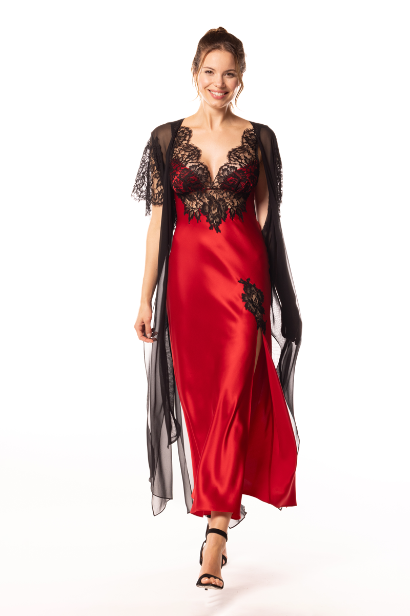 Woman wearing a red satin nightgown with black lace details on a white background