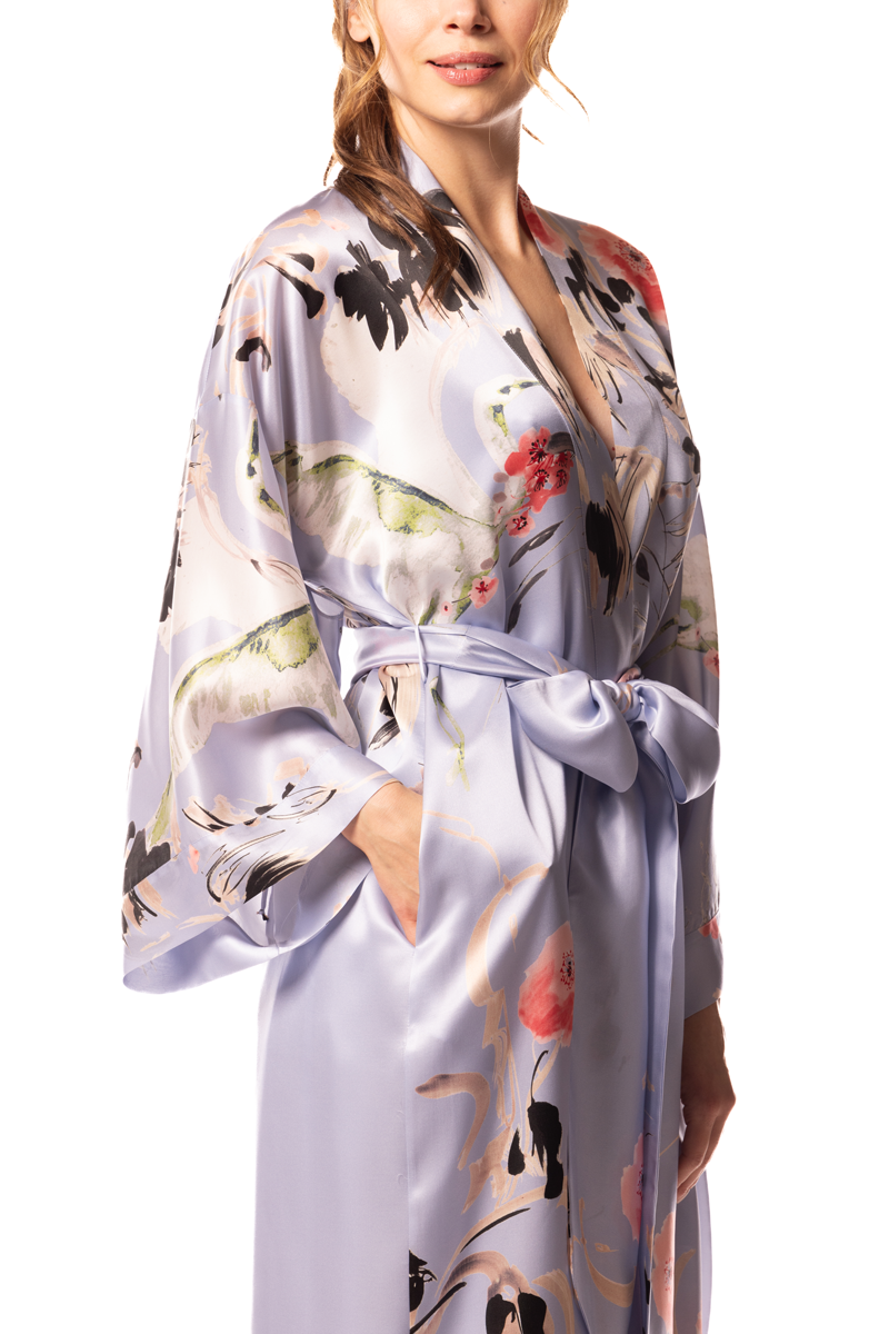 Woman wearing a floral silk robe on a white background