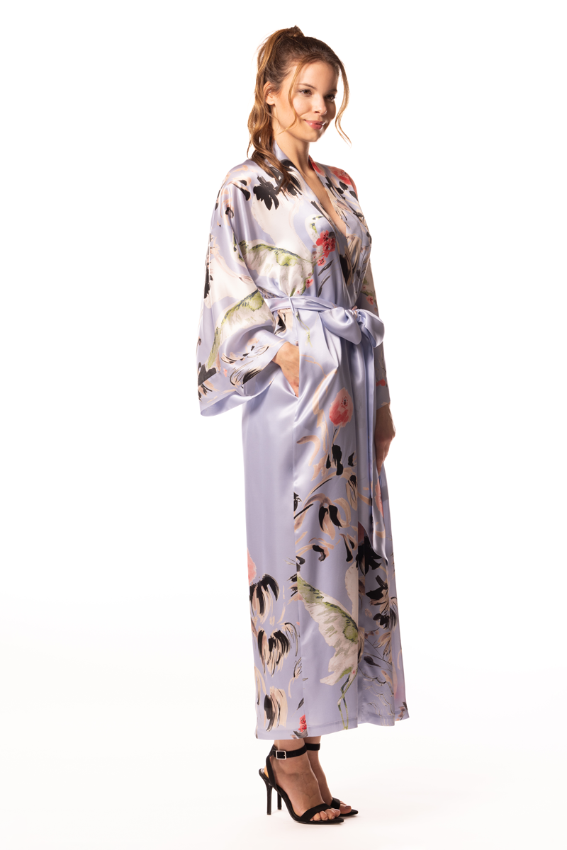 Woman wearing a floral silk robe on a white background